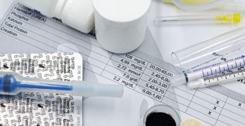 Vet supplies like syringes and medicines on blood test reports, suggesting medical care theme.