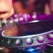 Close-up of a DJ's hands on mixing console at a vibrant party in Utrecht.