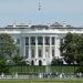 The White House in Washington DC, with tourists viewing from the lawn.